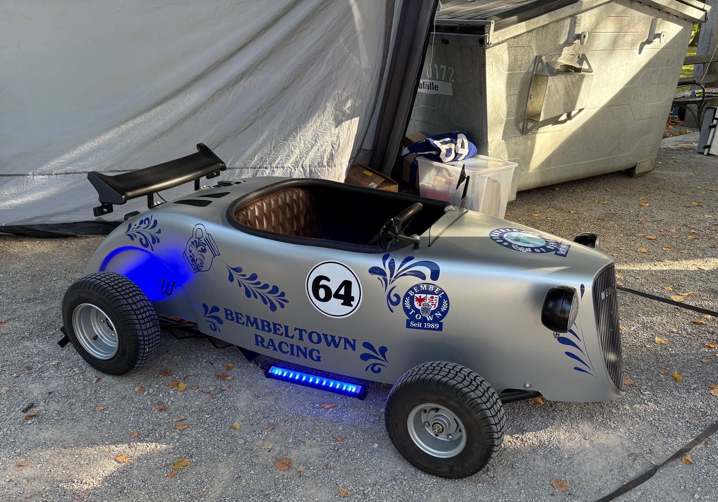 Mini Hot Rod mit blauer Unterbodenbeleuchtung neben dem Zelt